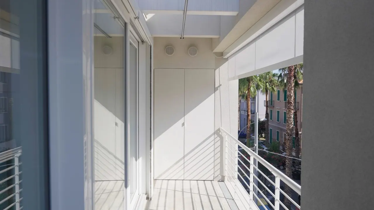 Balcone chiuso con lo scorrevole, la tenda a caduta e il box di chiusura in alluminio